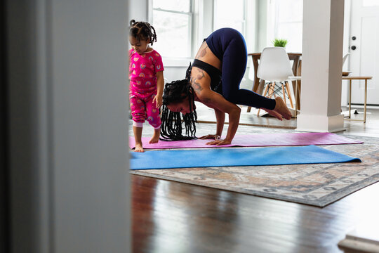 Woman with tattoo does yoga, crane crow