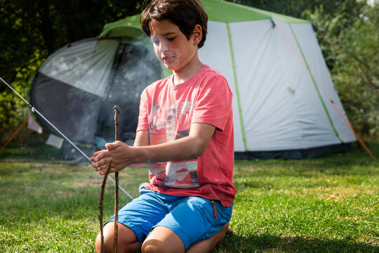 Boy making a camp fire