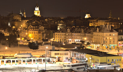 Lublin bus station against the background of the old town in winter night