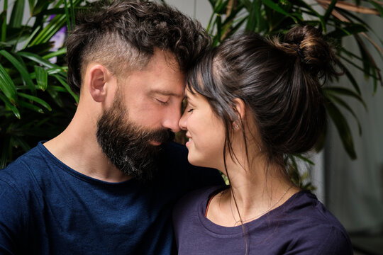 Portrait of adult couple touching affectionately with noses