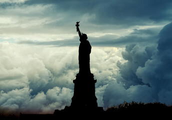New York, USA - November 2019: Silhouette of Statue of Liberty over dramatic full moon © CanYalicn
