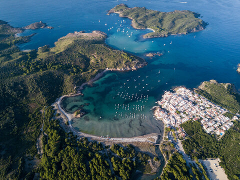 Boats moored in bay and coastal town, aerial view