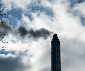 Smoke from chemical factory chimney on cloudy sky background. Ecology theme.