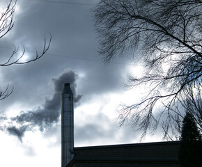 Smoke from chemical factory chimney on cloudy sky background. Ecology theme.