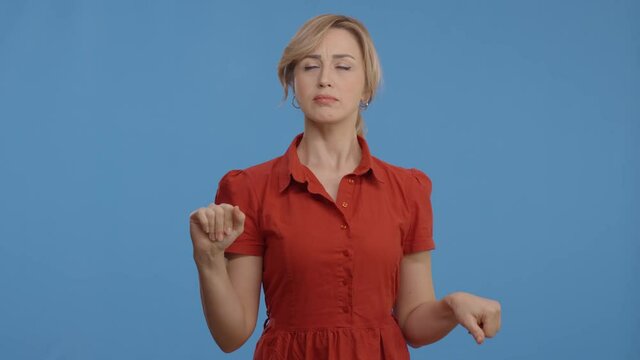 The worried pensive woman makes a difficult decision by thinking with her hand on her chin. Young woman pointing sideways with doubts on isolated background.Consider the solution and make a decision.