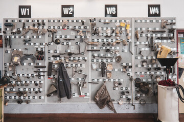 in  car workshop there are many spare parts hanging on the wall