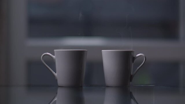 two cups of coffee at home with steam, evening together