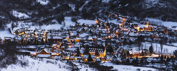 Spain, Cataluna, Baqueira, Ski resort covered with snow illuminated at dusk