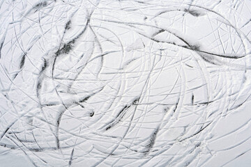 Skate tracks on snow and ice top view