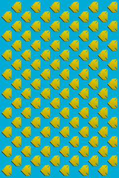 Pattern of yellow origami fish against blue background