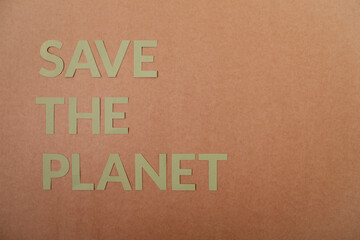 Save The Planet cardboard letters on a craft paper