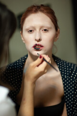 Beautiful fashion woman. Close emotional portrait of a redhead. Selective focus