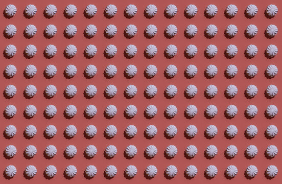 Pattern of rows of pink zefirs against brown background