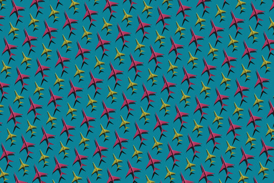 Pattern of pink and yellow origami airplanes