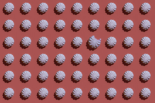 Pattern of rows of pink zefirs with single one missing bite