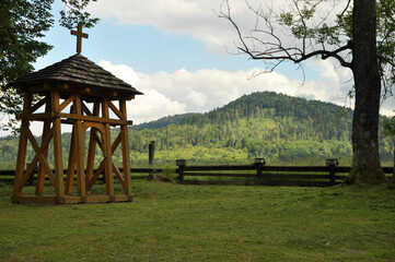 Fototapeta na wymiar bell, old bell tower, the green mountain landscape