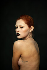 Beautiful fashion woman. Close emotional portrait of a redhead. Selective focus