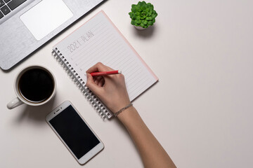 hand writing notepad. view from the top of the office desk table. Working space phone and coffee cup.