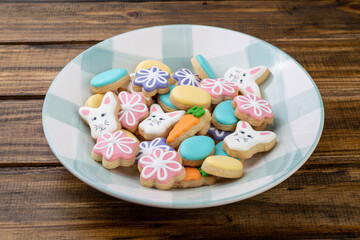 Easter cookies on a plate over wooden table