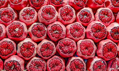 Pomegranate Closeup, Background. Group Of Ripe Pomegranates Fruits Neatly Laid Out On Counter In Store.