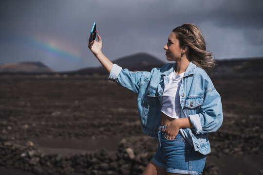Young tourist girl visiting "el cuervo" volcano, lanzarote, spain visiting Lanzarote vineyards that grow on the black soil of volcanic ash, which is carved into circular hollows that resemble craters on the Moon, Spain
