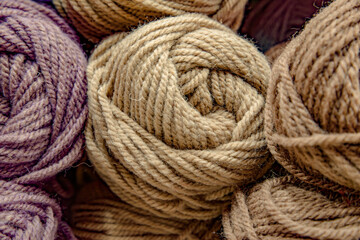 Skeins of woolen yarn on a shelf in a specialist store. Hobby and knitting retail