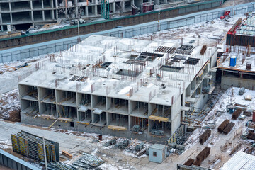 Top view of the construction of a multi-storey building in winter