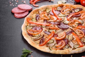 Fresh delicious pizza made in a hearth oven with sausage, pepper and tomatoes