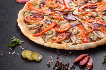 Fresh delicious pizza made in a hearth oven with sausage, pepper and tomatoes