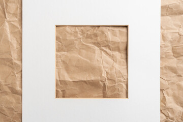 White paper picture frame on a crumpled wrinkled packaging wrapping background