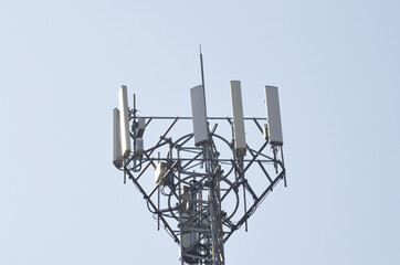 Closeup of a transmission tower on background of the clear blue sky
