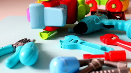 Children's toys in the form of tools close-up on a blue background selective focus.