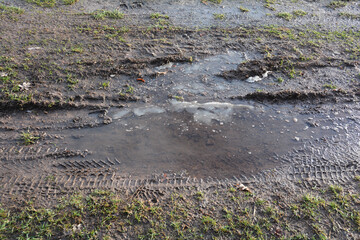 Muddy earth with meadow and ice