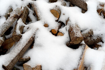 Firewood covered with snow in the wintertime.