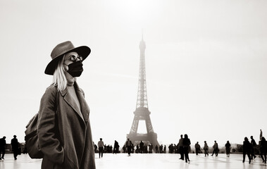 Fototapeta na wymiar Style woman in face mask and sunglasses with Eiffel tower on background