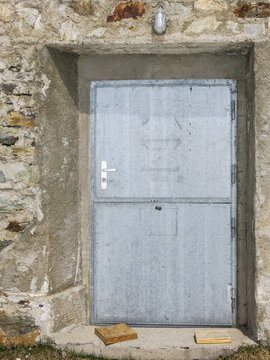 metal entrance door in stone barn