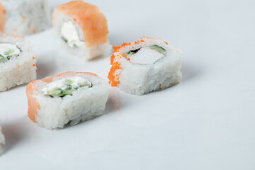 Mini sushi rolls with red caviar and cream cheese
