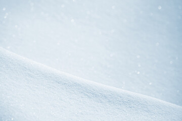 Fototapeta na wymiar Fresh clean white snow background texture. Winter background with snowflakes and snow mounds. Snow lumps. Seasonal landscape details. Soft beautiful bokeh.