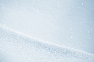 Fresh clean white snow background texture. Winter background with snowflakes and snow mounds. Snow lumps. Seasonal landscape details. Soft beautiful bokeh.