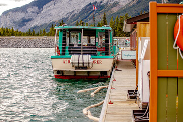 Tour boat parked along dock at Lake Minnewanka
