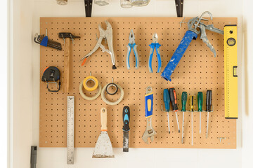 various construction tools hanging on the wall. High quality photo. - Powered by Adobe