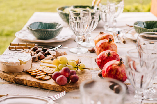 Table served with tableware and assorted ripe fruits and delicious appetizers on terrace