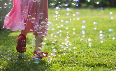 Little Girl Running Through Soap Bubbles - obrazy, fototapety, plakaty
