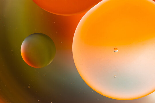 Closeup of abstract background with round shaped cells of vaccine of different sizes illuminated by colorful light