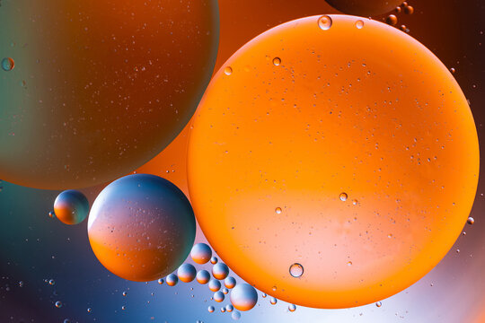 Closeup of abstract background with round shaped cells of vaccine of different sizes illuminated by colorful light