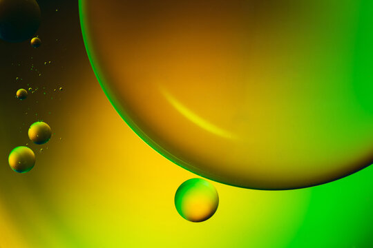 Closeup of abstract background with round shaped cells of vaccine of different sizes illuminated by colorful light