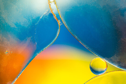 Closeup of abstract background with round shaped cells of vaccine of different sizes illuminated by colorful light