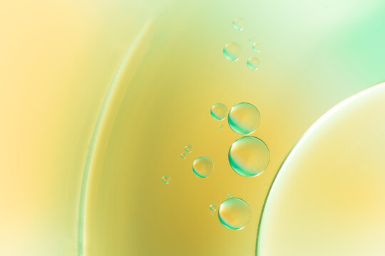 Closeup of abstract background with round shaped cells of vaccine of different sizes illuminated by colorful light