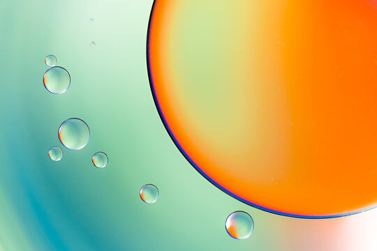 Closeup of abstract background with round shaped cells of vaccine of different sizes illuminated by colorful light