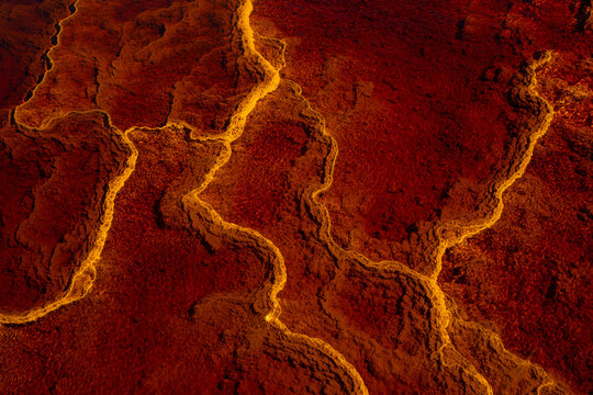 Majestic view of orange rock in river with fast flow in long exposure in Minas de Rio tinto